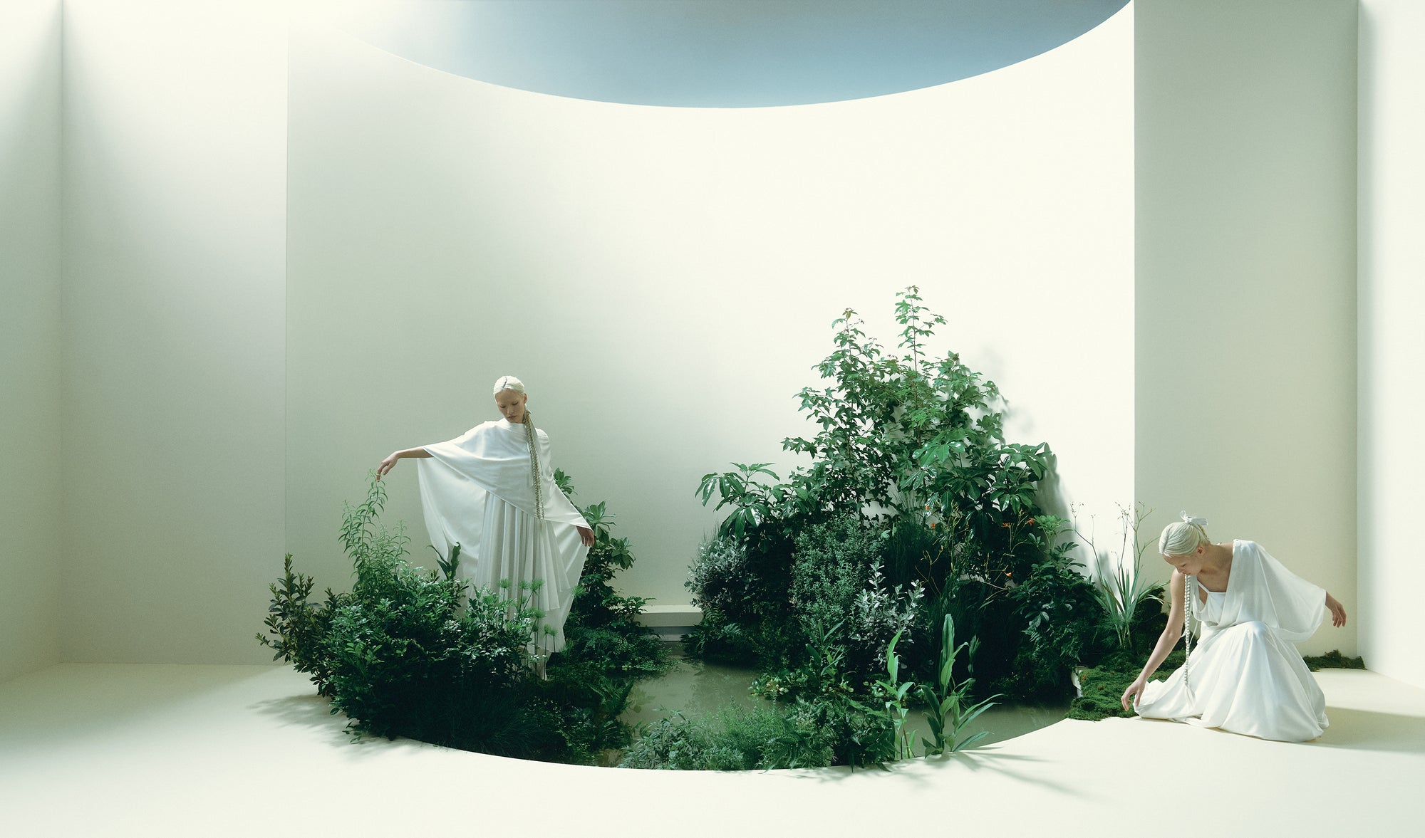Draws inward and tightens, conveying tension and vulnerability